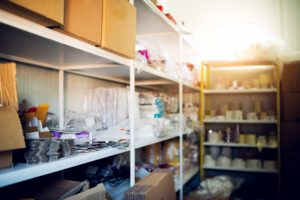 Home storage with metal shelves and lot of cartoon around.