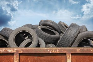 A pile of tires in a rusty container