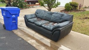 A couch beside the street walk